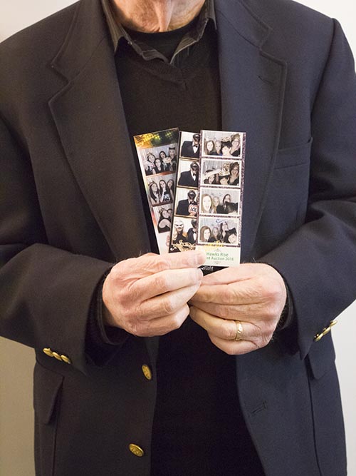 A man holding up his photos.