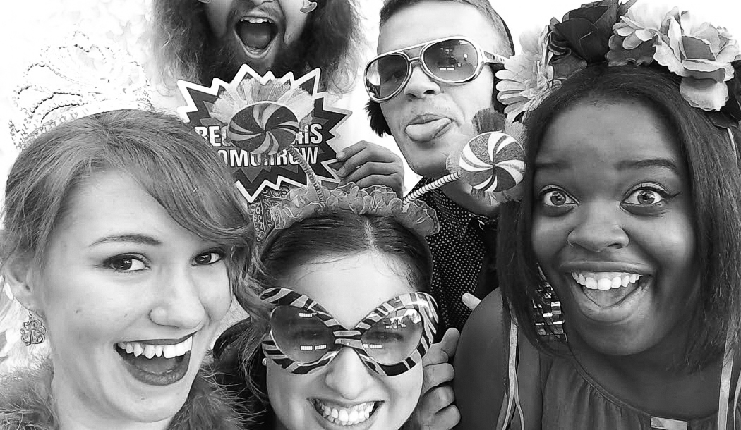 black and white photo of a group of friends in the photo booth